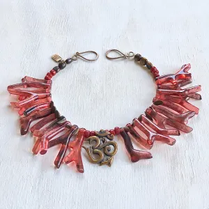 Om necklace with coral red shapes